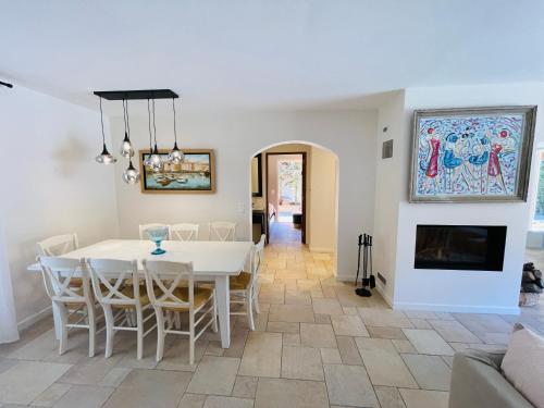 une salle à manger avec une table et des chaises et une cheminée dans l'établissement St Tropez 7km, Villa Gassinette, à Gassin