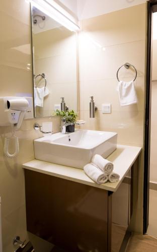 a bathroom with a sink and a mirror at SeaVista Studios in Negombo