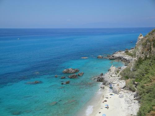 an aerial view of a beach with people in the water at Spacious Mansion in Parghelia near Sea in Parghelia