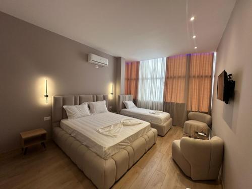 a hotel room with two beds and a couch at Luxury Hotel By Gjyshi in Qerrexhias