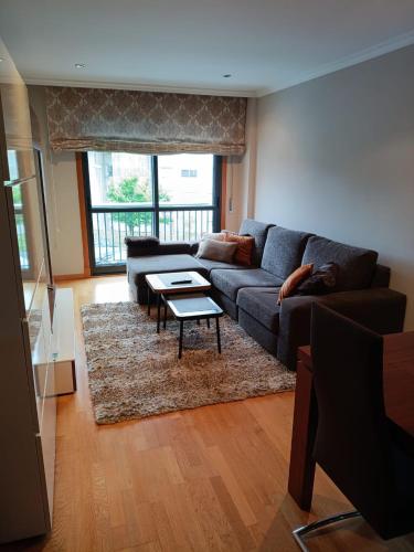 a living room with a couch and a table at A Devesa in Redondela