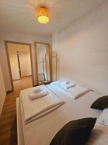 a bedroom with two beds with towels on them at Ljubljana Center Budget Apartment in Ljubljana