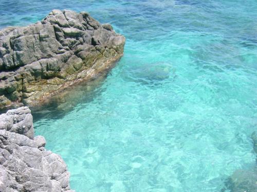 a view of the clear blue water near some rocks at Spacious Mansion in Parghelia near Sea in Parghelia