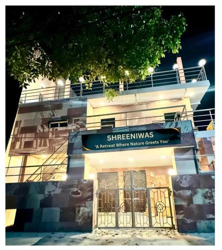 a building with a sign on the front of it at Shreenivas in Haridwār