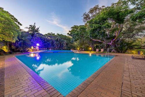 a swimming pool in a park at night at Sanbonani Hotel in Hazyview