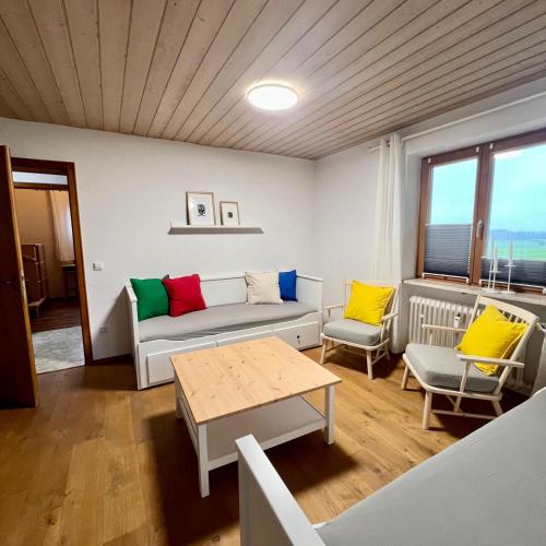 a living room with a couch and a table at Ferienwohnung Landurlaub in Bad Feilnbach
