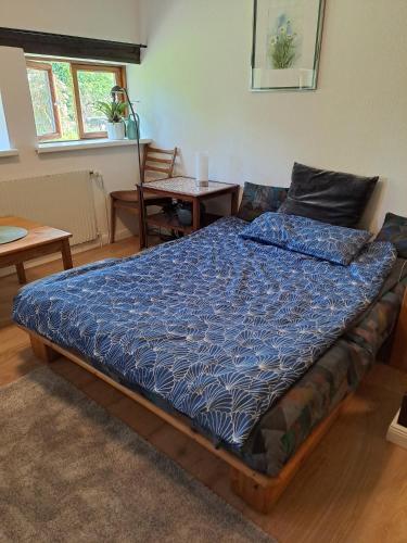 a bedroom with a bed with a blue comforter at Ferienwohnung Gitta in Helmstorf