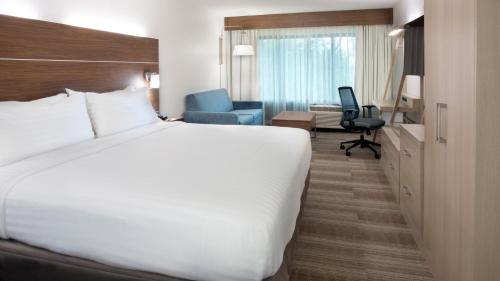 a hotel room with a large bed and a desk at Holiday Inn Express Hilton Head Island by IHG in Hilton Head Island