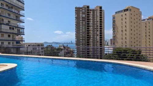 a large swimming pool on a balcony with buildings at Incredible sea views in Benidorm