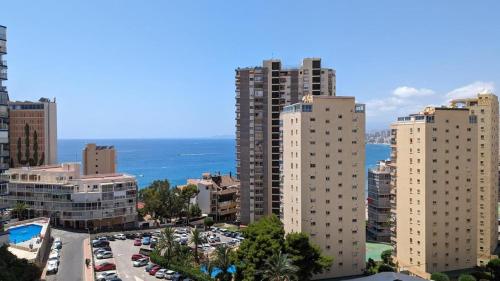 a view of a city with tall buildings and the ocean at Incredible sea views in Benidorm