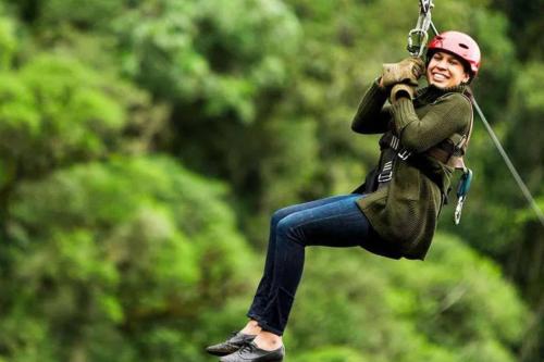 a woman is hanging on a zip line at Bald Eagle in Kingston Springs