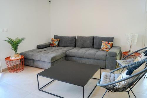 a living room with a couch and two chairs at Lou Tavan - Villa Rénovée avec Piscine & Jacuzzi - 4 Chambres in Le Lavandou