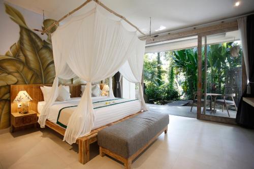 a bedroom with a bed with mosquito netting at Marni alas villa ubud in Tegalalang