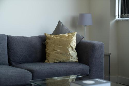 a blue couch with a pillow on a table at Bromley Station in Bromley