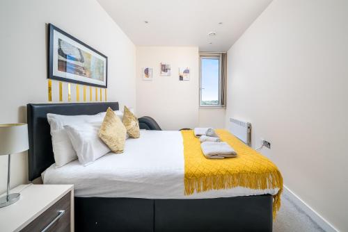 a bedroom with a large bed with a yellow blanket at Bromley Station in Bromley