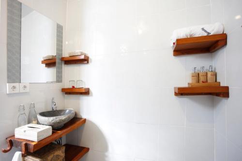 a bathroom with a sink and a mirror at Marni alas villa ubud in Tegalalang