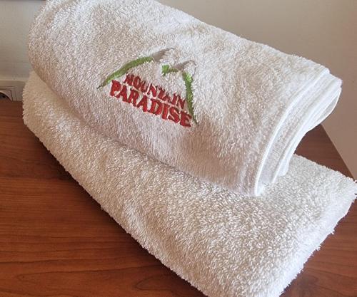 a stack of white towels sitting on top of a table at Mountain Paradise 1 - 1 Bright Two Floor Apartment - wifi -balcony in Bansko