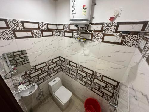 a bathroom with a toilet and a sink at Shreenivas in Haridwār
