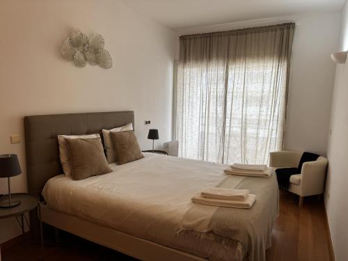 a bedroom with a bed with two towels on it at Riverside Expo in Lisbon