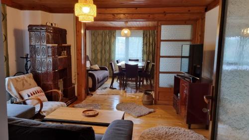 a living room with a table and a dining room at Pensiunea Mirela in Breaza