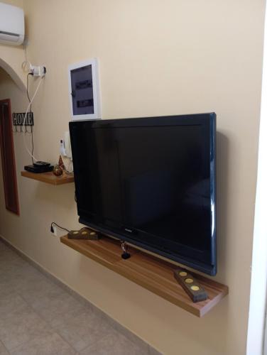 a flat screen tv sitting on a wall at Garden studio in Piraeus