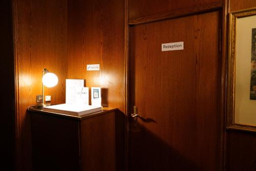 a room with a door and a sign that reads emergency at Hotel Xantener Eck in Berlin