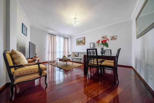 a living room with a table and chairs and a couch at Alex Apartment by Mth in Funchal