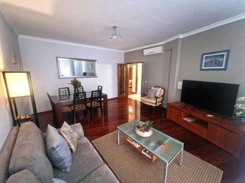 a living room with a couch and a flat screen tv at Alex Apartment by Mth in Funchal