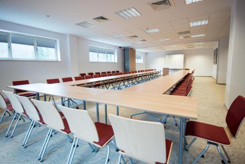 a large conference room with a long table and chairs at Hotel TTS**** Spa&Wellness Covasna in Covasna