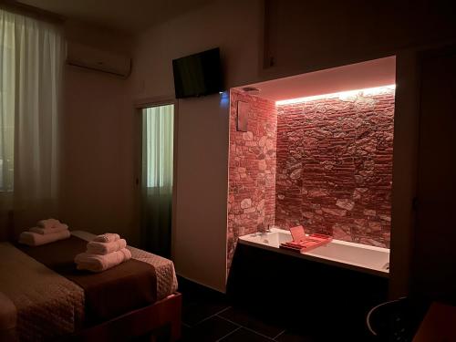 a bathroom with a sink and a brick wall at Mirellas dream in Vibo Valentia
