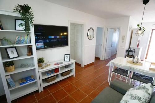 a living room with a couch and a table and a tv at Terraza, céntrico pueblo aparcamiento cerca in Icod de los Vinos