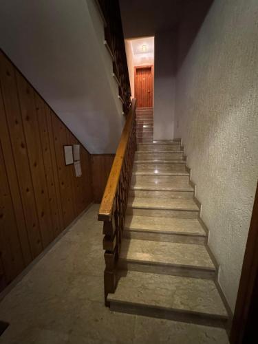 a stairway in a building with a wooden door at App4rent TANNE HAUS 6 Gallio in Gallio