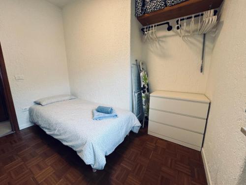 a small bedroom with a bed and a dresser at App4rent TANNE HAUS 6 Gallio in Gallio