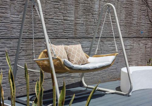 a swinging chair with pillows on a patio at The Great Escape at Shell Cove in Dunmore