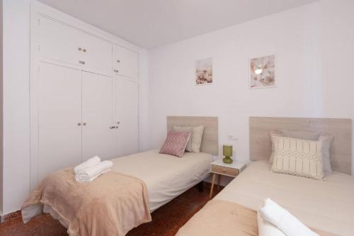 two beds in a room with white walls at Casa Sánchez. Old Town Marbella in Marbella