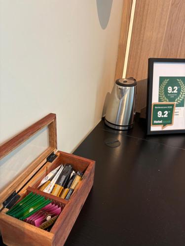 a wooden box on top of a table with pens at Tiny house in Arendal in Arendal