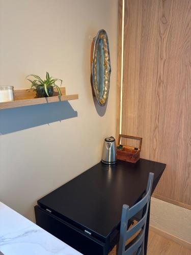 a black table with a tea kettle on it in a room at Tiny house in Arendal in Arendal