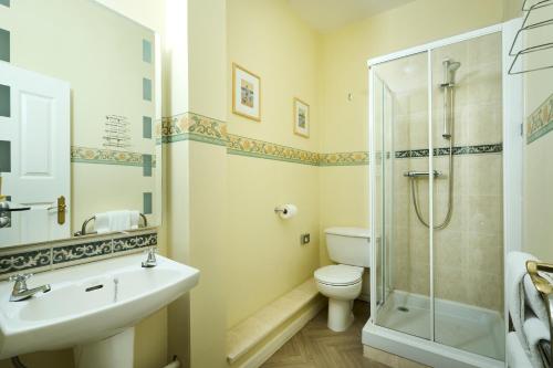 a bathroom with a shower and a toilet and a sink at Stage House Bed & Breakfast in Glenfinnan