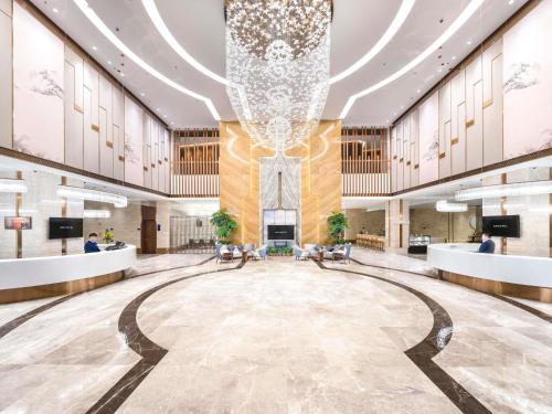 a rendering of a lobby with a chandelier at ibis Styles Changsha Intl Exhibition Ctr in Huangxing