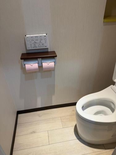 a bathroom with a toilet with two rolls of toilet paper at ホテルクレスパアルバ in Shizuoka