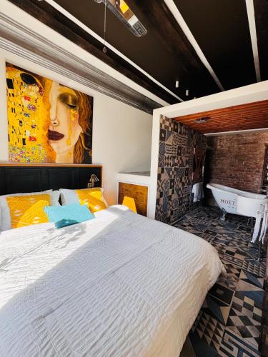 a bedroom with a large bed and a bath tub at Vibrant Downtown Studio Oasis in Liepāja