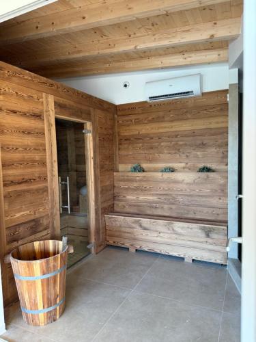 a room with wooden walls and a trash can at La Bergamina Hotel & Restaurant in Arcore
