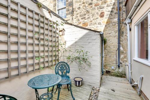 a patio with two chairs and a table at Learchild House - North East Escapes in Alnwick