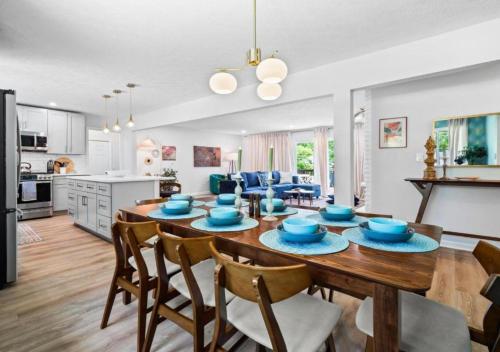 a kitchen and living room with a wooden table and chairs at Spacious and Luxury Designed Ranch with Game Room in Strongsville
