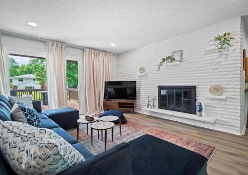 a living room with a blue couch and a fireplace at Spacious and Luxury Designed Ranch with Game Room in Strongsville