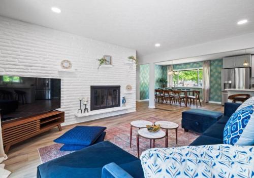 a living room with blue furniture and a fireplace at Spacious and Luxury Designed Ranch with Game Room in Strongsville