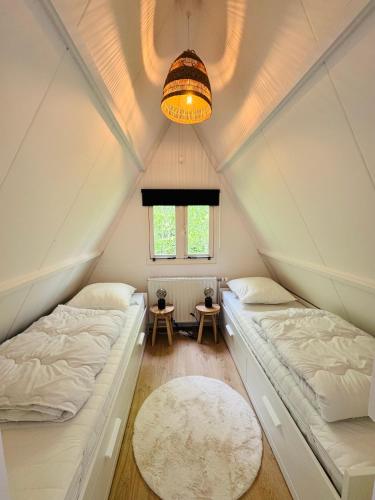 a room with two beds in a attic at Maison Olé Olé Durbuy in Durbuy