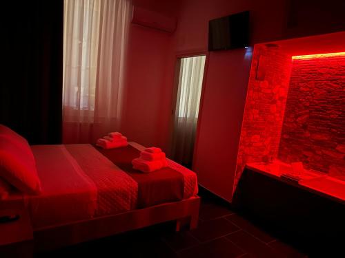 a red room with a bed and a mirror at Mirellas dream in Vibo Valentia
