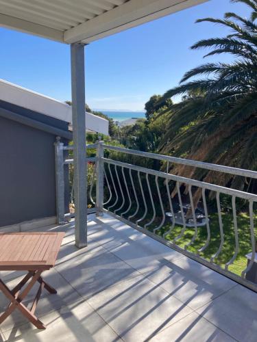 a balcony with a view of the ocean at Bloemenzee Boutique B&B in Gordonʼs Bay