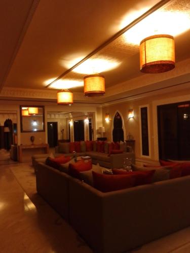 a living room with couches and tables and lights at Maria in Najem
